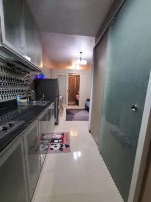 a kitchen with glass cabinets and a counter top at King of kings at SEA RESIDENCES in Manila