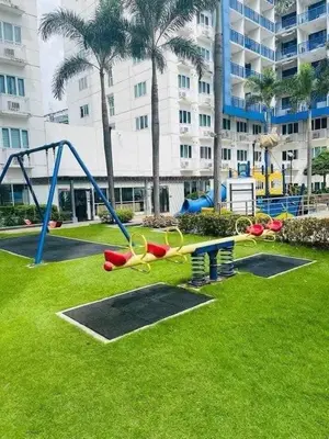 a park with a playground with a slide and scissors at King of kings at SEA RESIDENCES in Manila