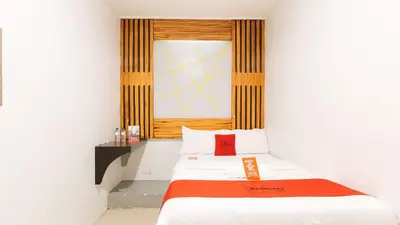 a small room with a bed and a window at RedDoorz near Quiapo Church Manila in Manila