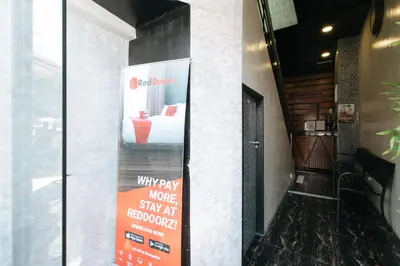 a sign that says why pay more to stay at home at RedDoorz near Quiapo Church Manila in Manila