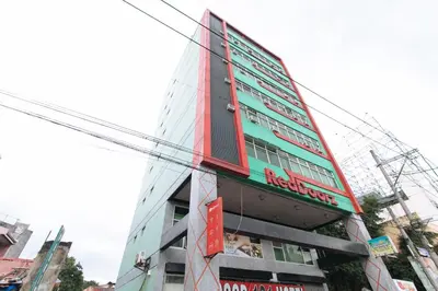 a tall building with a sign on the side of it at RedDoorz near Quiapo Church Manila in Manila