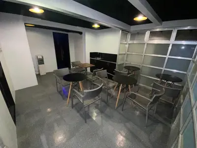 a group of tables and chairs in a room at ARK Hostel City Center Manila in Manila