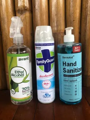 three bottles of cleaning products sitting on a wooden table at INN D’ZaireH in Molino
