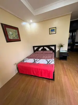 a bedroom with a bed with a red bedspread at INN D’ZaireH in Molino