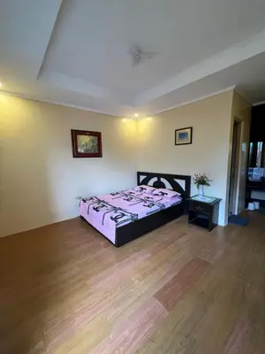 a bedroom with a bed and a wooden floor at INN D’ZaireH in Molino