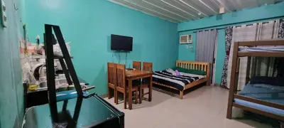 a room with a bed and a desk and a room with a bed at Mhavic family room ,group friend good for 6 guest in Manila