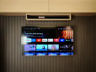a wall with a tv with different screens on it at Sithonia Suite, Shore Residences Tower C near MOA in Manila