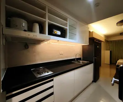 a kitchen with a sink and a counter top at Sithonia Suite, Shore Residences Tower C near MOA in Manila