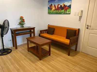 a living room with a couch and a table at AZURE C1 with balcony wifi MULTIPLE UNITS near airport in Manila