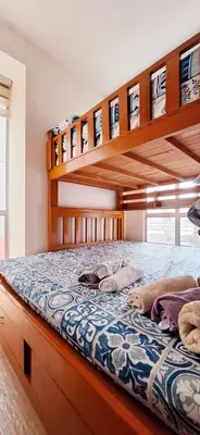 a bedroom with two bunk beds in a room at U607 Sunshine100 Netflix 65InchesTV Wifi Karaoke Swimming Pool in Manila