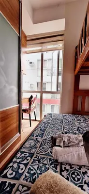 a bedroom with a large bed and a chair at U607 Sunshine100 Netflix 65InchesTV Wifi Karaoke Swimming Pool in Manila
