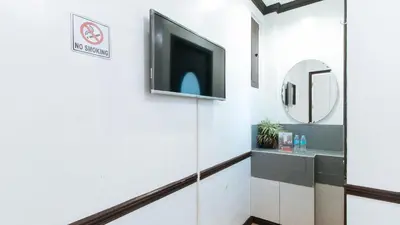 an elevator lobby with a flat screen tv on the wall at RedDoorz Plus at Villa Gloria Taguig in Manila