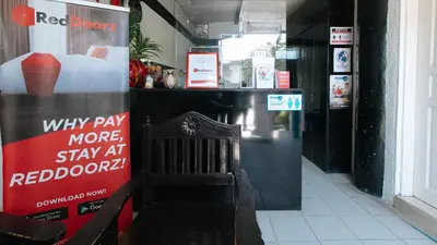 a room with a red moon sign and a chair at RedDoorz Plus at Villa Gloria Taguig in Manila