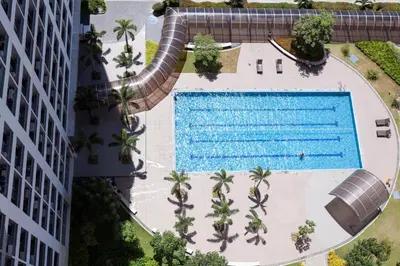 an overhead view of a swimming pool next to a building at Elegant Living at Grace Residences T3-2206 Taguig-Steps from SM Aura and BGC in Manila
