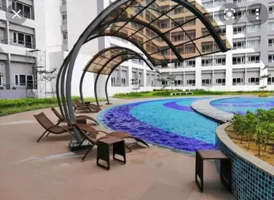 a swimming pool in the middle of a building at Elegant Living at Grace Residences T3-2206 Taguig-Steps from SM Aura and BGC in Manila