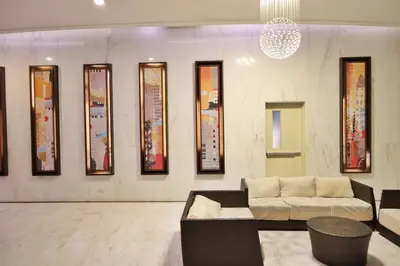 a living room with a couch and a wall of mirrors at BGC Fort Victoria in Manila