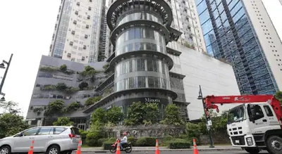 a tall building with cars parked in front of it at BGC Fort Victoria in Manila