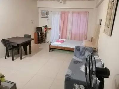a living room with a couch and a table at Your City•Home Apartment in Manila