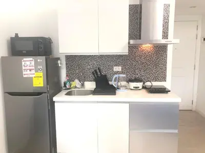 a kitchen with a refrigerator and a sink at 1217 Urban Simplicity in Manila
