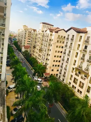 an aerial view of a street with palm trees and buildings at Apartments across NAIA Terminal 3 in Manila