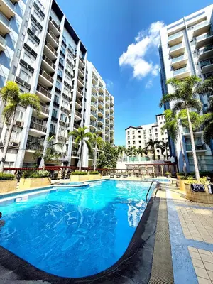 a large swimming pool in front of tall buildings at Apartments across NAIA Terminal 3 in Manila