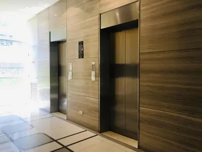 a lobby with two elevators in a building at Apartments across NAIA Terminal 3 in Manila