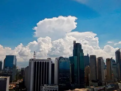 a group of buildings in a city with a cloudy sky at POBLACION SUITES - Polaris in Manila