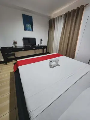 a bed with a stuffed animal sitting on top of it at POBLACION SUITES - Polaris in Manila