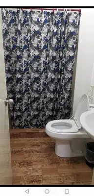 a bathroom with a toilet and a shower curtain at POBLACION SUITES - Polaris in Manila