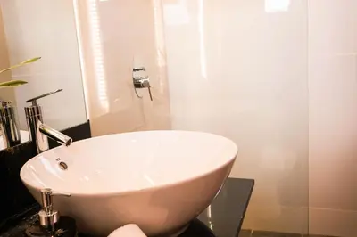 a white sink in a bathroom with a shower at UNWND Boutique Hotel Makati in Manila