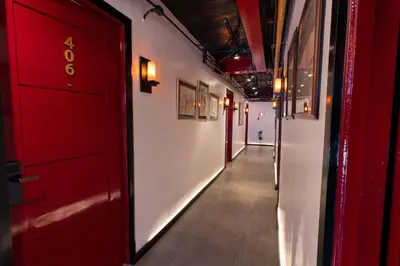 a corridor of a hallway with red doors and a corridorngthngthngth at UNWND Boutique Hotel Makati in Manila