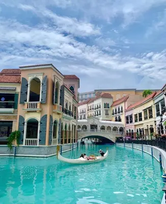 a group of people in a gondola in a canal at Morgan Suite BGC across5 Venice Canal Mall free Pool gym in Manila