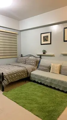 a living room with two beds and a green rug at Morgan Suite BGC shortwalk4 Venice Canal Mall free pool gym in Manila