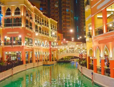 a canal in the middle of a city at night at Morgan Suite BGC shortwalk4 Venice Canal Mall free pool gym in Manila