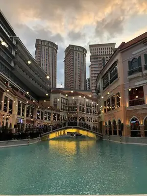 a building with a pool of water in a city at Morgan Suite BGC shortwalk4 Venice Canal Mall free pool gym in Manila