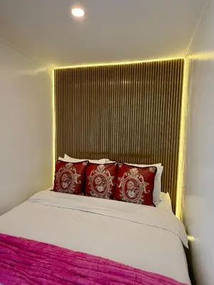 a bed with red pillows in a room at MAKATI Isabela Luxury in Manila