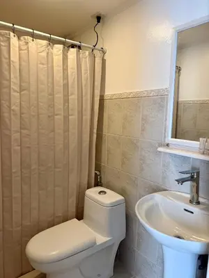 a bathroom with a toilet and a sink at MAKATI Isabela Luxury in Manila
