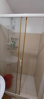 a shower with a glass door in a bathroom at Chateau Elysee a2 near Airport,Wifi Netflix Kitchen in Manila