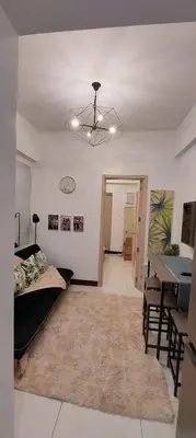 a living room with a bed and a dining table at Chateau Elysee a2 near Airport,Wifi Netflix Kitchen in Manila