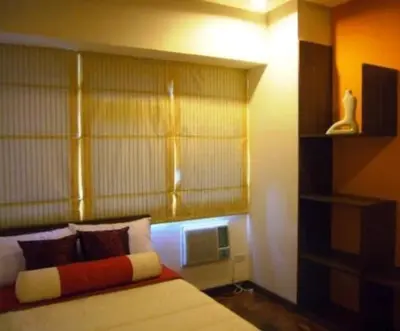 a bedroom with a bed with a large headboard at Chateau Elysee a2 near Airport,Wifi Netflix Kitchen in Manila