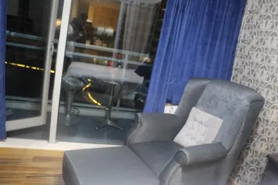 a living room with a chair and a window at Azure Urban Resort Residence a4 near airport mall with wavepool in Manila