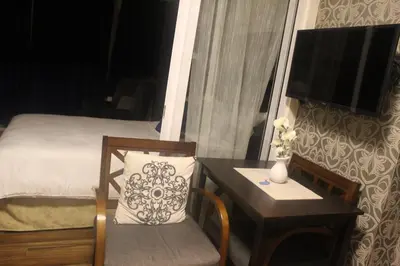a bedroom with a bed and a table and a table and chair at Azure Urban Resort Residence a4 near airport mall with wavepool in Manila