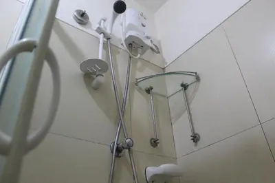 a shower in a bathroom with a shower head at CHATEAU ELYSEE A10 near airport in Manila