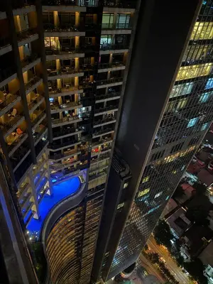 a view from the top of a tall building at night at City View at The Gramercy Residences in Makati