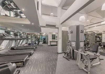 a gym with rows of treadmills and machines at Vivere Hotel and Resorts in Manila
