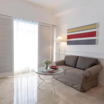 a living room with a couch and a glass table at Vivere Hotel and Resorts in Manila