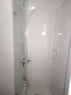 a shower with a glass door in a bathroom at One Palm Tree Villas-Terminal 3 Pasay Manila in Manila