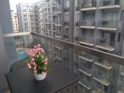 a plant on a table on a balcony with apartment buildings at One Palm Tree Villas-Terminal 3 Pasay Manila in Manila