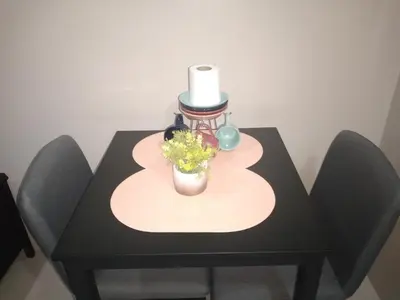 a black table with a vase of flowers on it at One Palm Tree Villas-Terminal 3 Pasay Manila in Manila