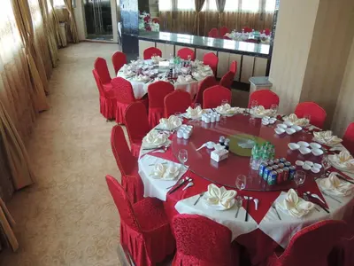 a room filled with tables and chairs with red table cloth at Dela Chambre Hotel in Manila